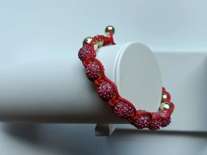 Braided bracelet with red bead